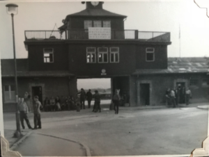 “Buchenwald, main entrance. Prisoners (former) wait around, anxious to serve as guides in various languages to soldier visitors” Source: Jacob Kalman archive